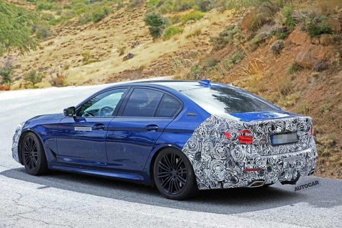 aria-label="facelifted bmw 5 series spied in saloon and estate forms"